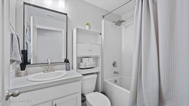 full bathroom featuring shower / bathtub combination with curtain, vanity, toilet, and a textured ceiling