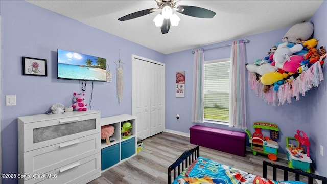 recreation room featuring light hardwood / wood-style flooring and ceiling fan