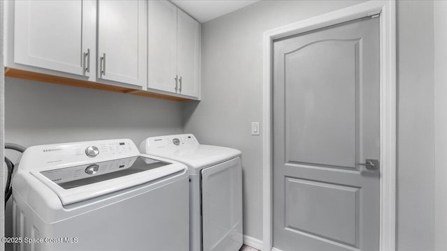 laundry area featuring cabinets and washer and clothes dryer