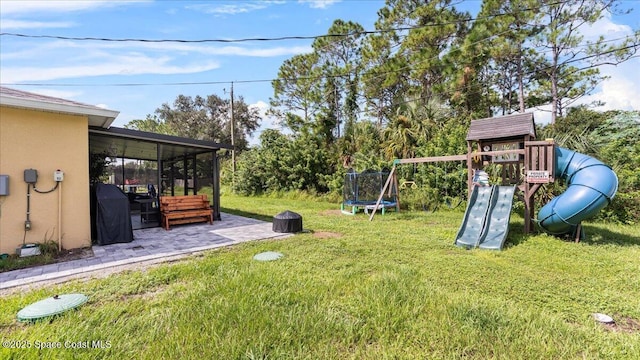 view of yard with a trampoline, a patio area, and a playground