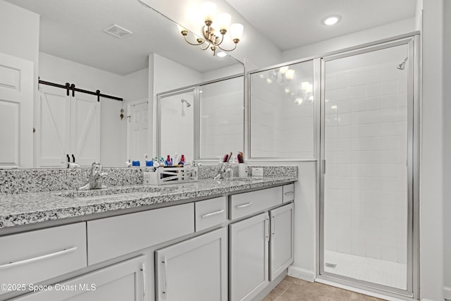 bathroom with vanity, an enclosed shower, and tile patterned floors