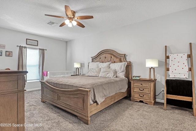 carpeted bedroom with a textured ceiling and ceiling fan