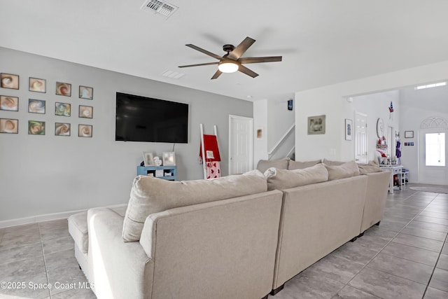 tiled living room featuring ceiling fan