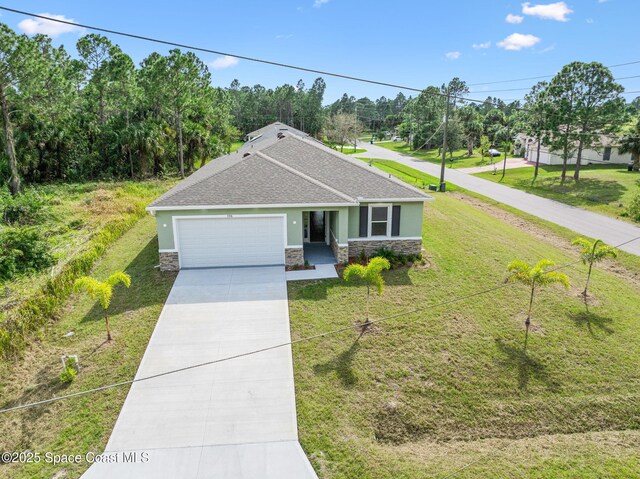 view of front of property featuring a garage, a front yard, stone siding, and concrete driveway