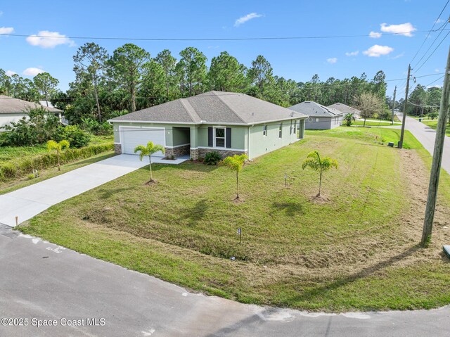 ranch-style home featuring a garage, stone siding, driveway, stucco siding, and a front yard