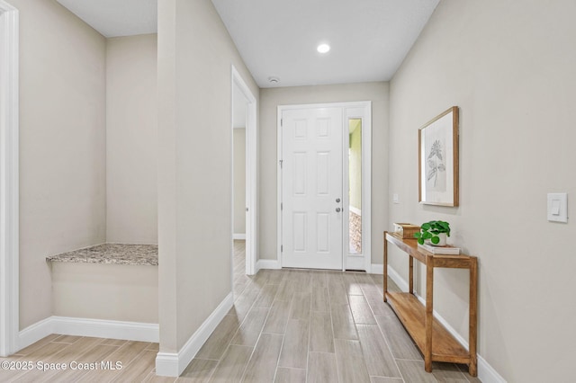 entrance foyer featuring baseboards and wood finish floors