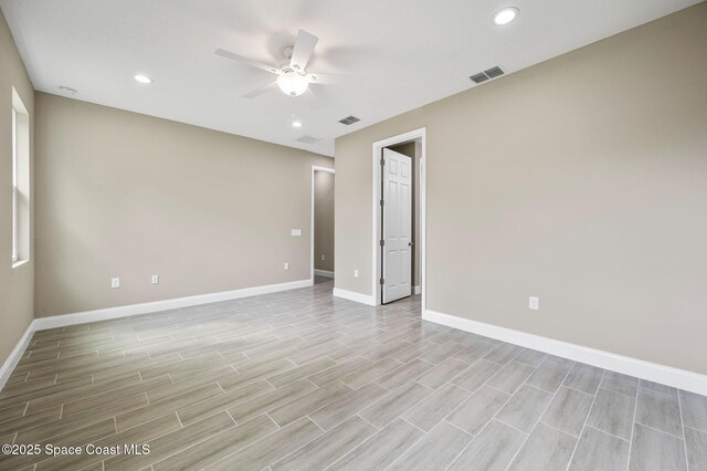 unfurnished room with a ceiling fan, recessed lighting, visible vents, and baseboards