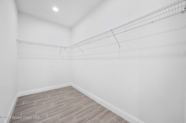 spacious closet featuring wood finish floors