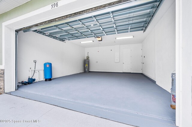 garage with water heater and a garage door opener