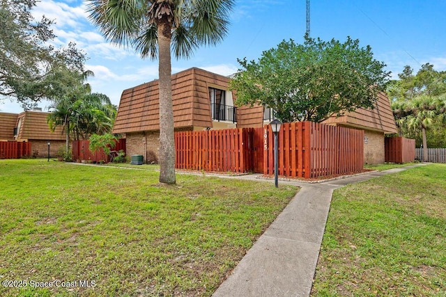 view of side of property featuring central AC and a lawn