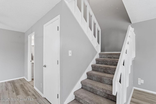 stairs with hardwood / wood-style floors