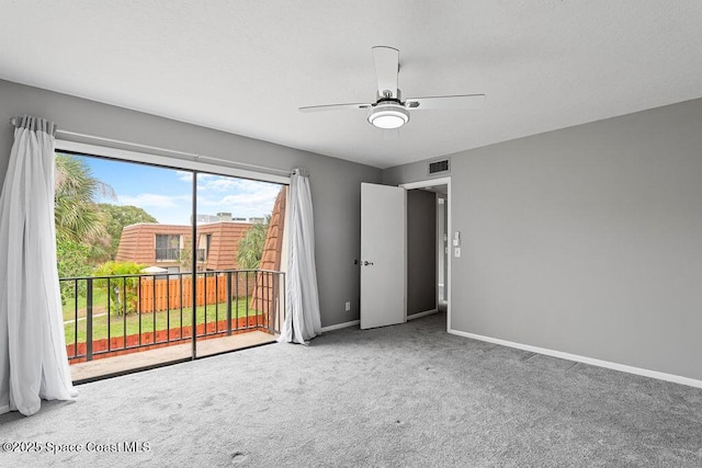 carpeted spare room with ceiling fan