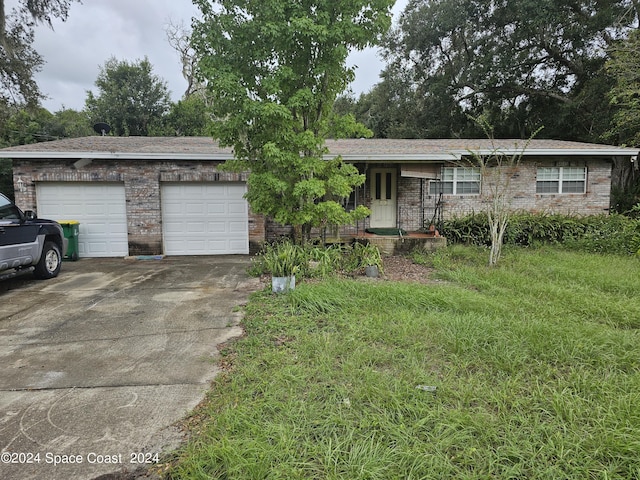 single story home featuring a garage and a front yard