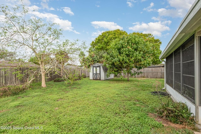 view of yard featuring a fenced backyard, an outdoor structure, and a storage shed