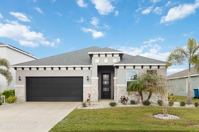 prairie-style home featuring a garage and a front lawn