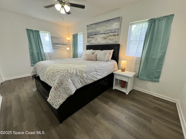 bedroom with dark hardwood / wood-style floors and ceiling fan