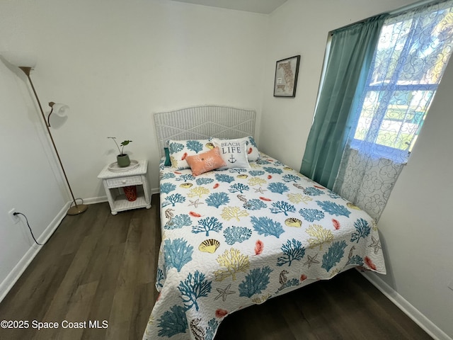 bedroom featuring dark wood-type flooring and multiple windows