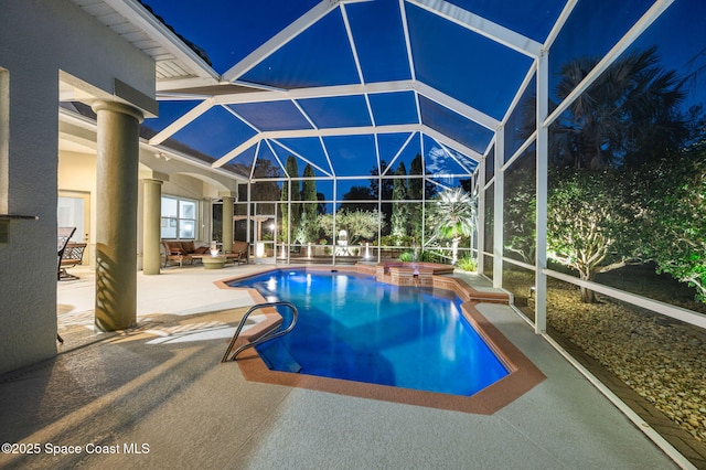 pool with a patio area, a hot tub, and glass enclosure