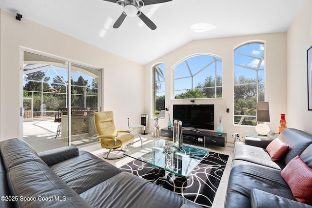 living room featuring lofted ceiling, ceiling fan, and a sunroom