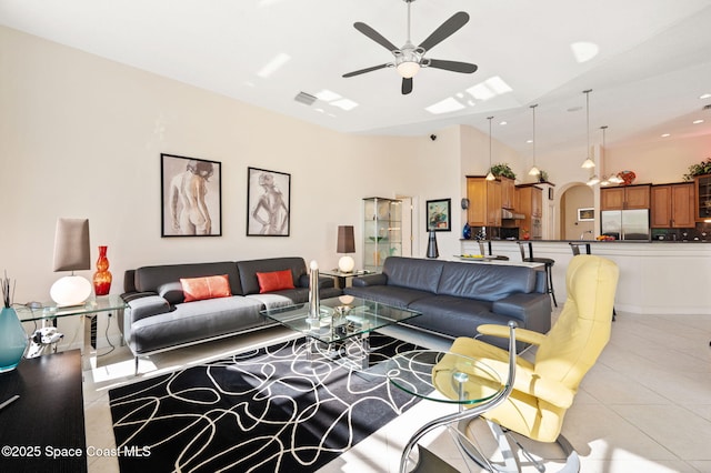 living room featuring arched walkways, a ceiling fan, and light tile patterned flooring