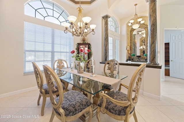 dining area with a chandelier, light tile patterned floors, decorative columns, and baseboards