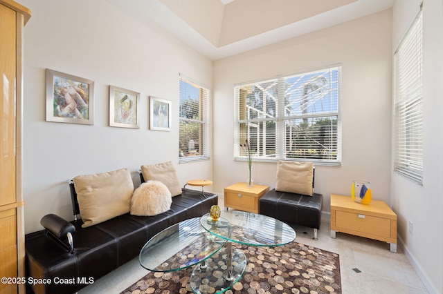 living area featuring baseboards