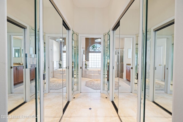 interior space with french doors, light tile patterned flooring, and a towering ceiling