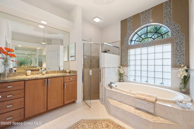 full bathroom with a bath, a stall shower, plenty of natural light, and vanity