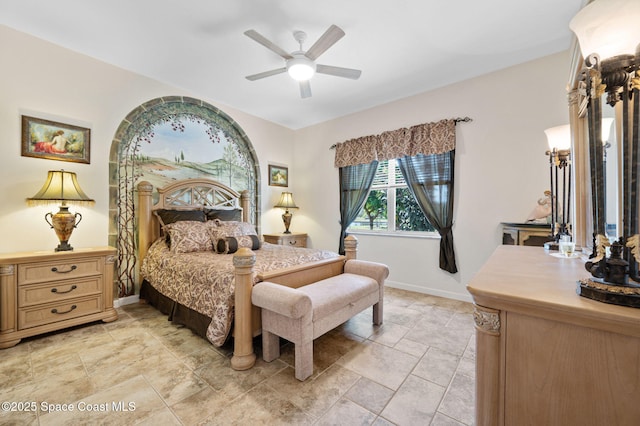 bedroom with ceiling fan and baseboards