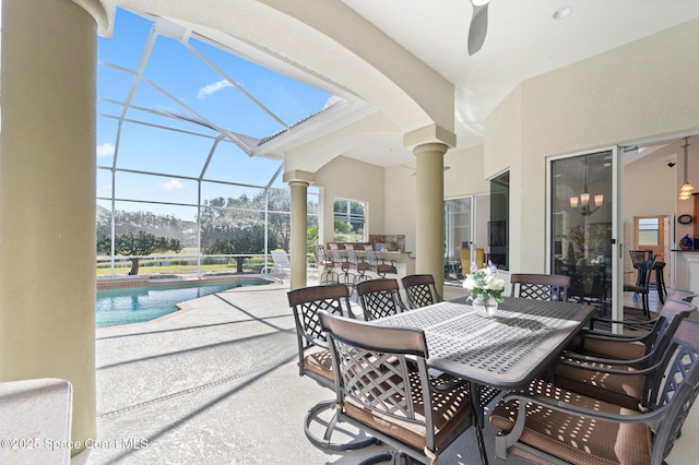 exterior space with outdoor dining area, a lanai, and an outdoor pool