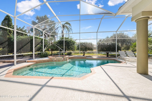 view of pool with a patio, a pool with connected hot tub, and glass enclosure