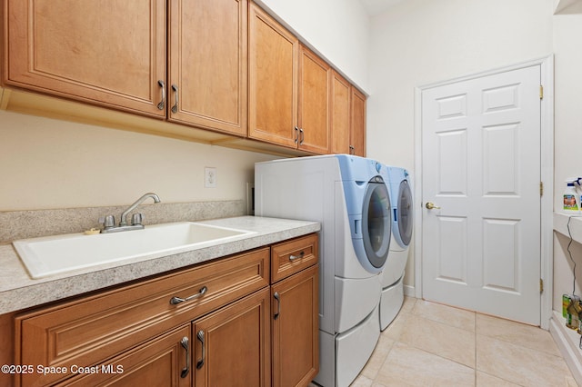 laundry area with light tile patterned floors, a sink, cabinet space, and washer and dryer