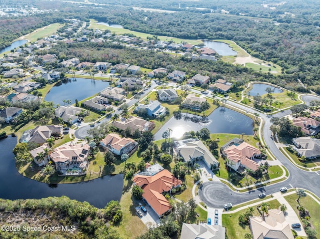 drone / aerial view featuring a residential view and a water view