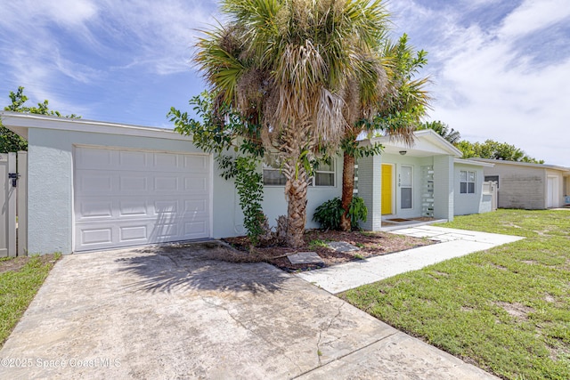 single story home with a garage and a front lawn