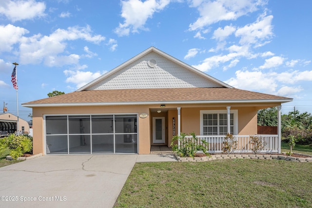 view of front of home with a garage, a front lawn, and covered porch