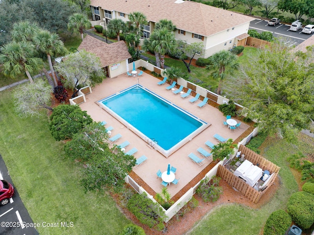 view of swimming pool featuring an outbuilding and a patio