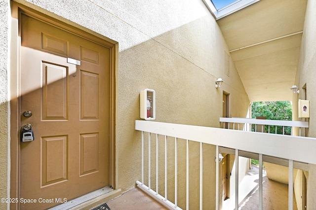 view of exterior entry featuring a balcony