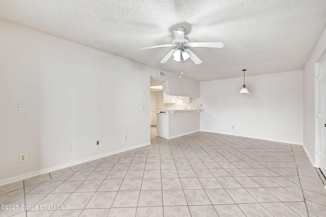 unfurnished living room with a textured ceiling and ceiling fan