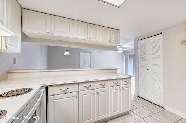 kitchen with light tile patterned floors and white cabinets