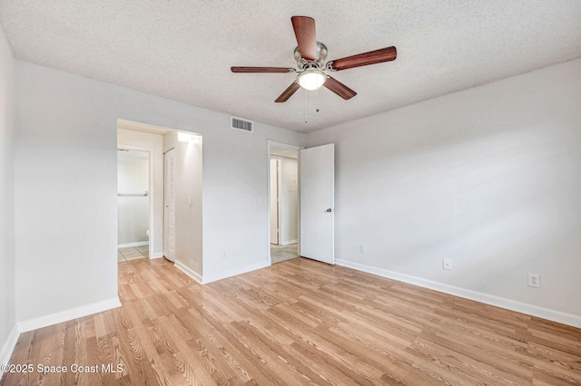 unfurnished bedroom with ceiling fan, a textured ceiling, and light wood-type flooring