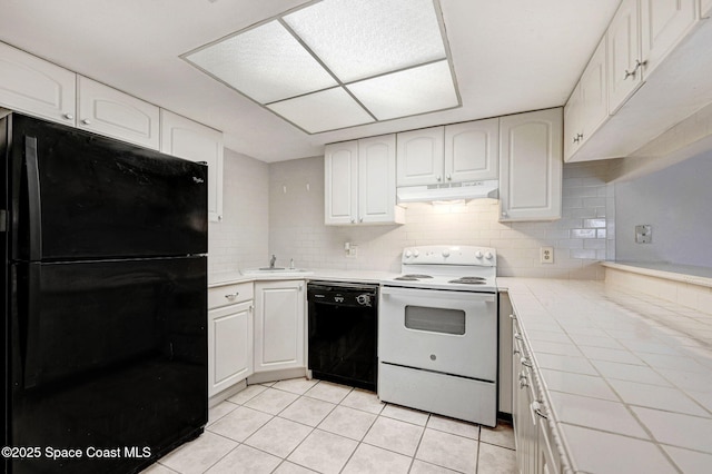 kitchen featuring white cabinetry, tile counters, and black appliances