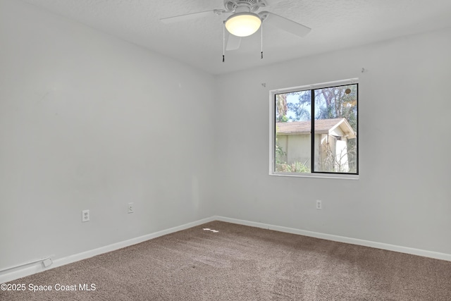 carpeted spare room with ceiling fan and a textured ceiling