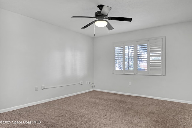 unfurnished room featuring ceiling fan and carpet