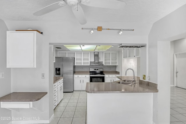 kitchen with stainless steel appliances, sink, white cabinets, and wall chimney exhaust hood