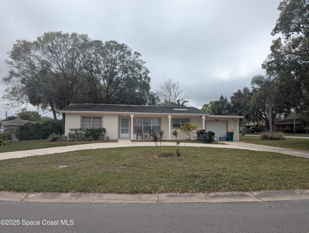 ranch-style house with a garage and a front yard