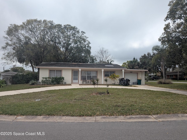 ranch-style house with a garage and a front yard