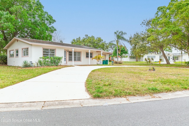 single story home with a front lawn, driveway, and stucco siding