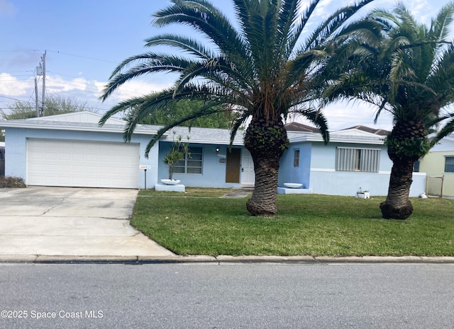 single story home featuring a front yard, an attached garage, and driveway