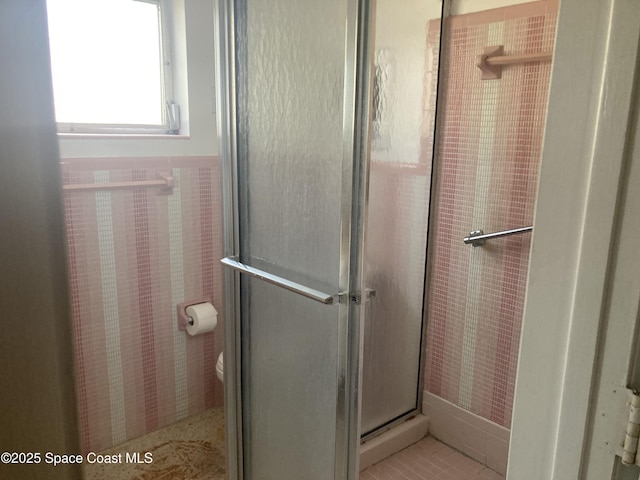 full bathroom with toilet and a shower stall