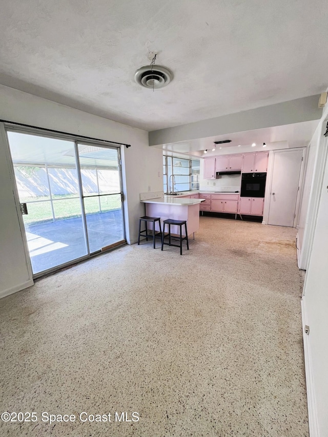 living area featuring light speckled floor